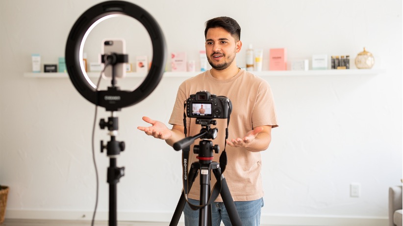 Content creator filming authentic product video in home studio